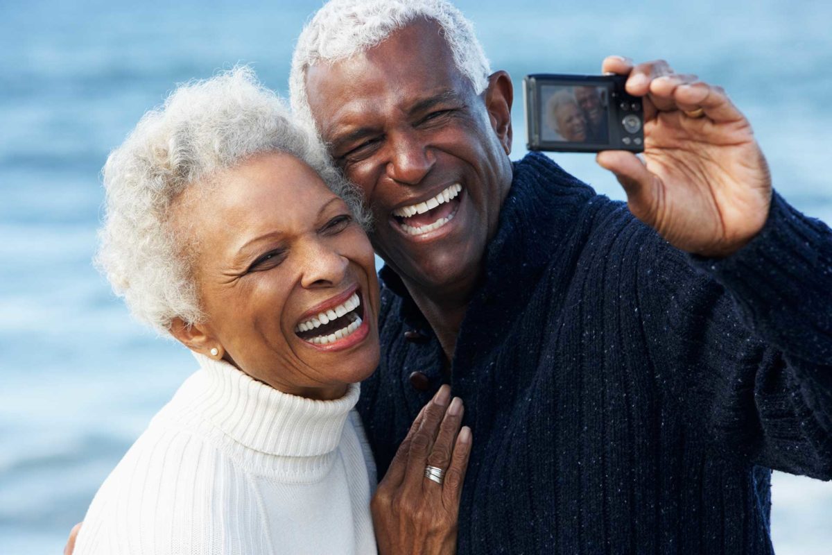 older houston dental implant couple taking selfie